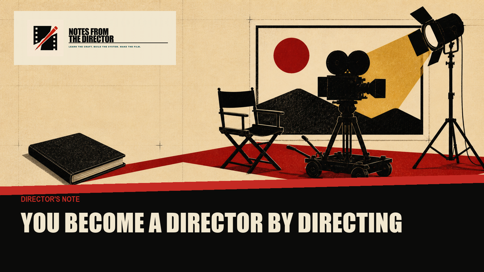 A closed directing book sits beside an open cut-paper film set with a camera rolling under a red production light